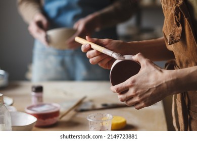 Pottery studio workshop, people making clay bowls, treditional craft