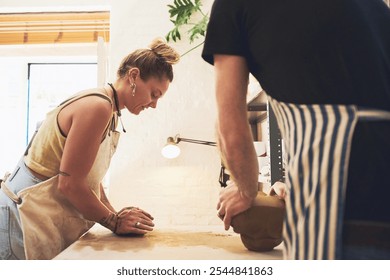 Pottery, teamwork and sculpture with woman in workshop for partnership, small business and creative. Clay, production and art process with people in studio for gallery, ceramic and talent together - Powered by Shutterstock