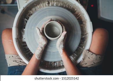 Pottery Workshop for Beginners, Top View Shot of professional Female Ceramic Artist Working on Pottery Wheel Makes Future Mug or Vase, Workshop Ceramic Handmade Artisan Clay Artist People - Powered by Shutterstock