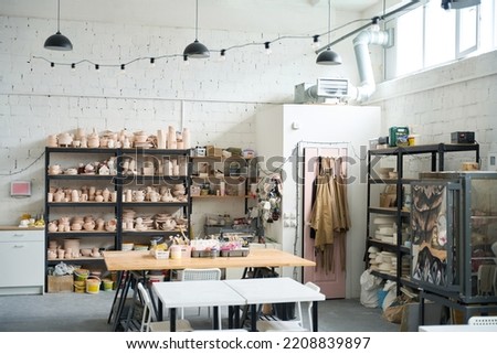 Pottery workshop with crockery, working tools and tables