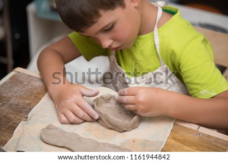 Pottery workshop for kids, raw clay, sculpting tools, glazing and painting clay pots