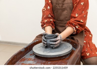 Pottery workshop. Pottery studio content. A little girl makes a vase of clay. Clay modeling. The concept of children's creativity. - Shutterstock ID 2255311459