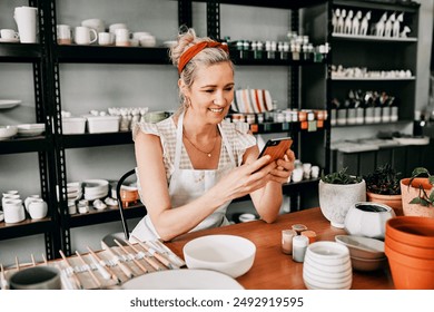 Pottery workshop, woman and smartphone with typing, internet and stoneware products in store. Expert, entrepreneur and potter with cellphone, startup and network with promotion for online service - Powered by Shutterstock