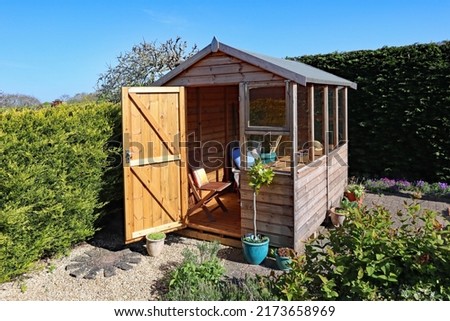 A potting shed in a back garden, used as a place to sit and relax [[stock_photo]] © 