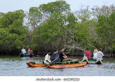 POTTUVIL, SRI LANKA - AUGUST 17, 2014 : Tourists Enjoy A Late Afternoon Pontoon Boat Ride On The Pottuvil Lagoon On The East Coast Of Sri Lanka.