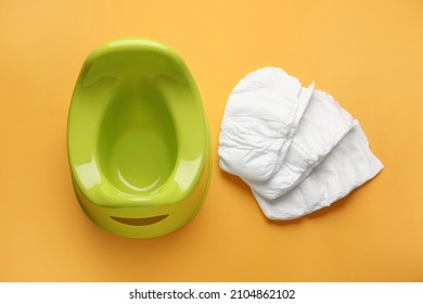 Potty And Diapers On Orange Background