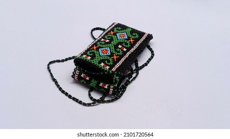 A pouch bag made of beads with traditional design isolated on a white background