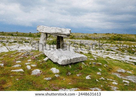 Poulnabrone Dolmen in Ireland, Uk. in Burren, county Clare. Period of the Neolithic with spectacular landscape. Exposed karst limestone bedrock at the Burren National Park. Rough Irish nature.