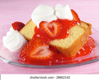 Pound cake with strawberries, strawberry glaze, and whipped cream.