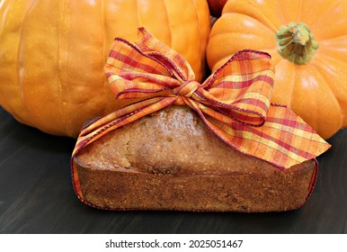 Pound Cake Wrapped In A Festive Fall Ribbon With Pumpkins In The Background.  Hostess Gift Idea.