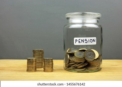 Pound Coins In A Glass Jar. Saving Money In A Pension Pot Concept.