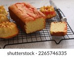 Pound lemon cake served on wire rack with grey background, selected focus