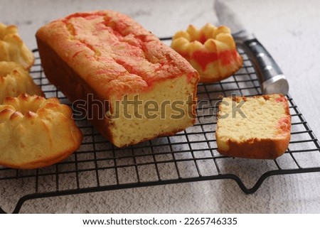 Pound lemon cake served on wire rack with grey background, selected focus