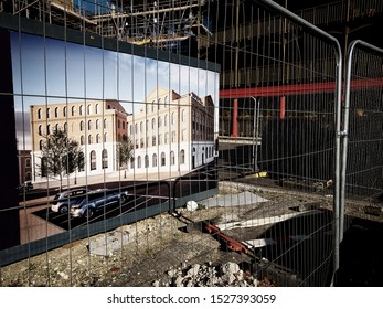 POUNDBURY, DORCHESTER, UK - October 21 2018: Building Site Perimeter Hoarding Showing Artists Impression Of Building Under Construction.