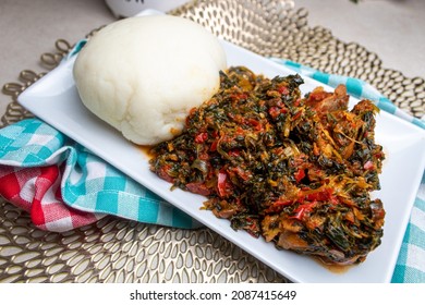 Pounded Yam Fufu and Efo Riro is a traditional meal from West African Nigerian. Yam pounded in a Mortal with a pestle to form a Dough like texture paired with Efo Rieo Spinach stew