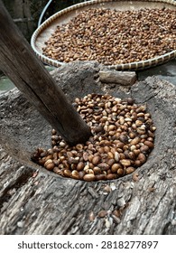 pounding coffee beans using traditional methods