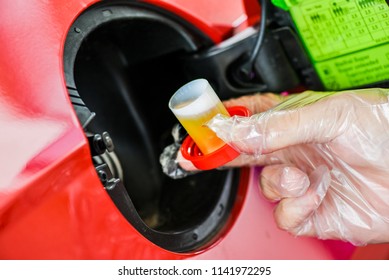 Pour additive liquid into car tank. Maintenance for long use without repair. Additional fluid for gasoline. - Shutterstock ID 1141972295