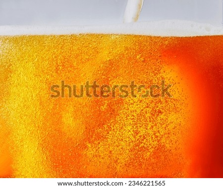 Pour the beer into a large glass with fresh and beautiful beer foam and a beautiful golden background. wide viewing angle