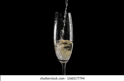 Pour Champagne Into An Empty Glass. On A Black Background