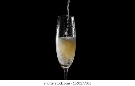 Pour Champagne Into An Empty Glass. On A Black Background