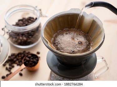 Pour hot water over the coffee powder.Make drip coffee. - Shutterstock ID 1882766284