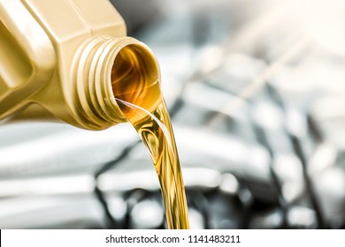 Pour motor oil to car engine. Fresh yellow liquid change with back light. Maintenance or service vehicle concept.