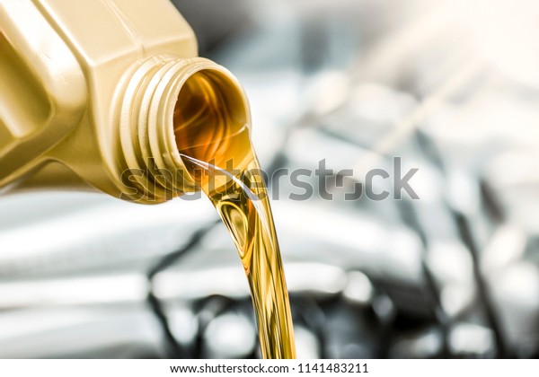Pour motor\
oil to car engine. Fresh yellow liquid change with back light.\
Maintenance or service vehicle\
concept.