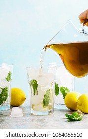 Pour From Pitcher Traditional Iced Tea With Lemon And Ice In Tall Glasses