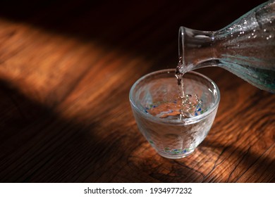 Pour sake into a transparent sake set