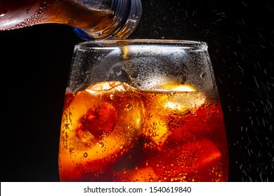 Pour Soft Drink In Glass With Ice Splash On Dark Background,Castillo De Coca, Soda, Cola, Pouring, CarbonatedมSoft Drink Being Poured Into GlassมSoda, Cola, Drink, Drinking Glass, Carbonated