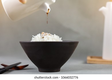 Pour soy sauce into cooked rice - Powered by Shutterstock