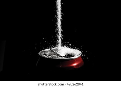 Pour Sugar On Soft Drink Can Against Deeply Black Background