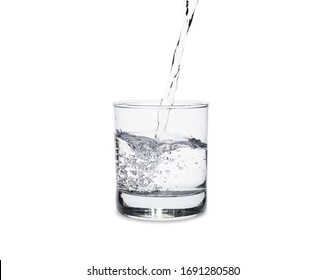 Pour Water In Glass Isolated On White Background With Clipping Path.