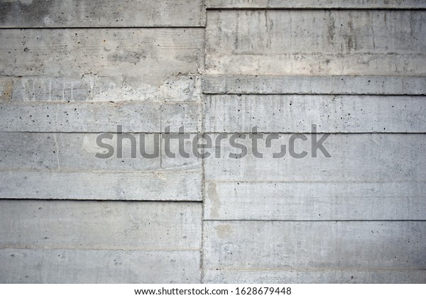 Poured Concrete Wall with Textured Pattern of Wooden\
Planks 
