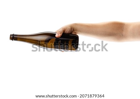 Pouring alcohol drink. Cropped image of male hand holding bottle of white wine isolated over white background. Concept of alcohol, drink, party, degustation, holiday. Copy space for ad
