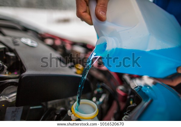 Pouring\
antifreeze liquid, Antifreeze screen wash\
