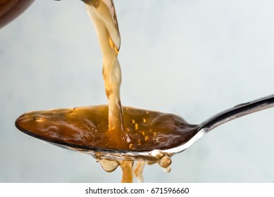 Pouring Apple Cider Vinegar on a Spoon