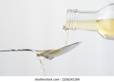 Pouring Apple Cider Vinegar In A Spoon