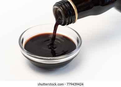 Pouring Balsamic Vinegar Into An Ingredient Bowl