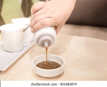Pouring BBQ Sauces On Cups