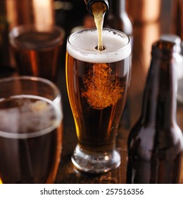 Pouring Beer From Bottle Into Glass At Bar