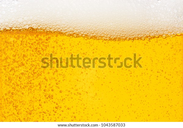Pouring beer with bubble froth in glass\
for background on front view wave curve shape texture foam ,  drink\
alcohol celebration party holiday new year\
concept