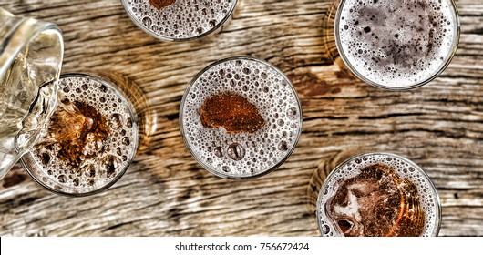 Pouring Beer.glasses With Beer Stand On A Wooden Table.Closeup. View From Above.