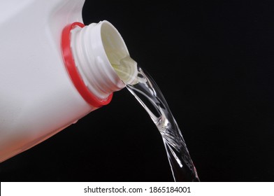Pouring bleach close up on black background - Shutterstock ID 1865184001