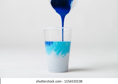 Pouring Blue Acrylic Paint Into Cup For Acrylic Pour Painting.