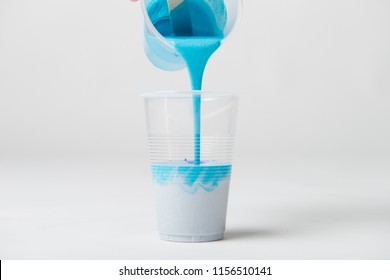 Pouring Blue Acrylic Paint Into Cup For Acrylic Pour Painting.