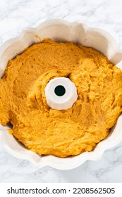 Pouring Cake Batter Into A Greased Bunt Cake Pan To Bake Pumpkin Bunt Cake.