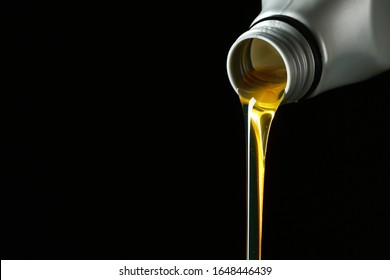 Pouring Car Oil On Dark Background