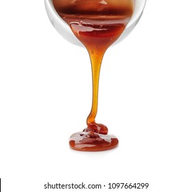 Pouring Caramel Sauce Onto White Background