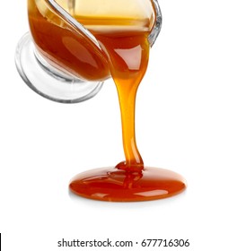 Pouring Caramel Sauce Onto White Background